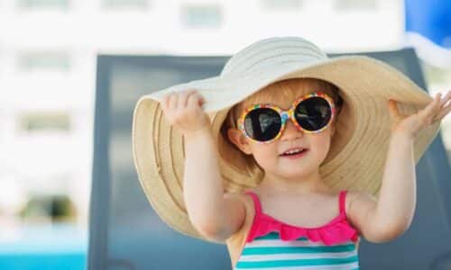 How should children be protected from the sun?
