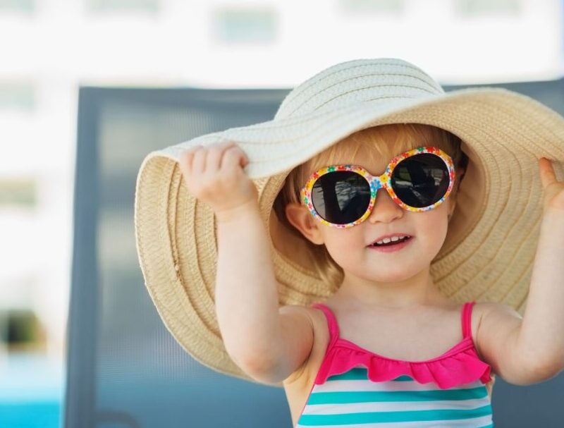 How should children be protected from the sun?